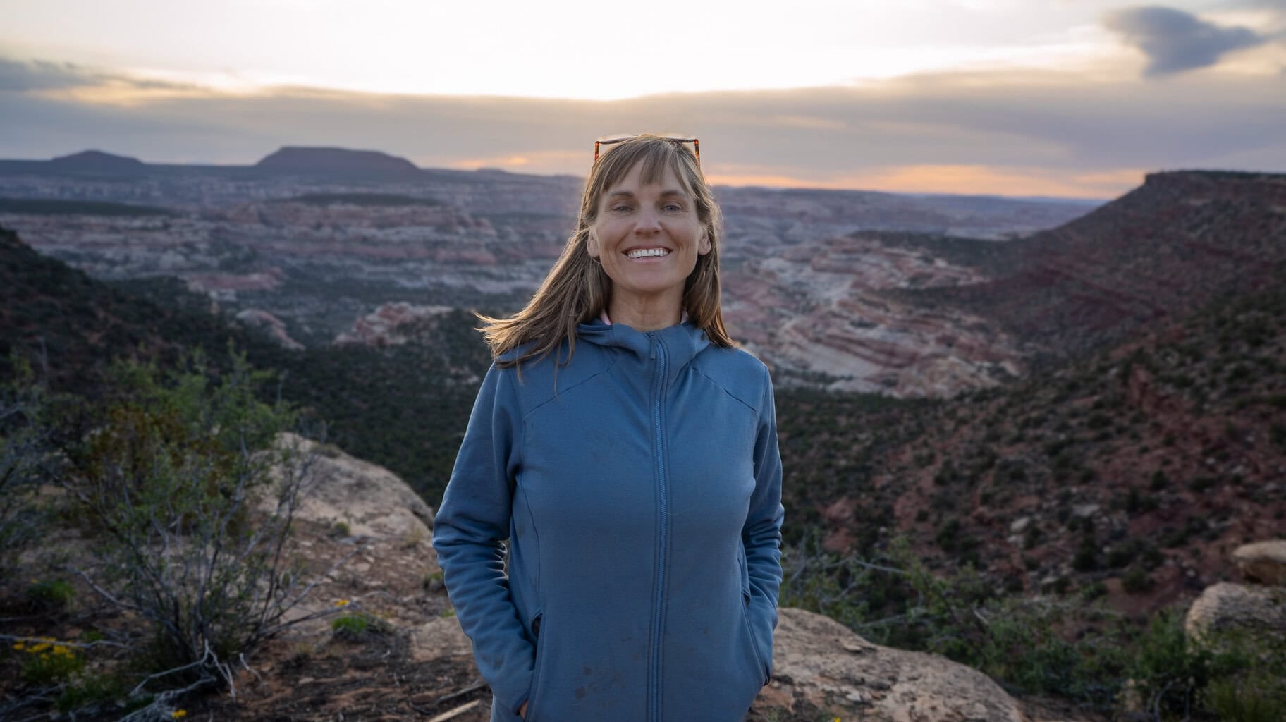 Kristen Bor on the edge of a cliff at sunset in Bears Ears National Monument
